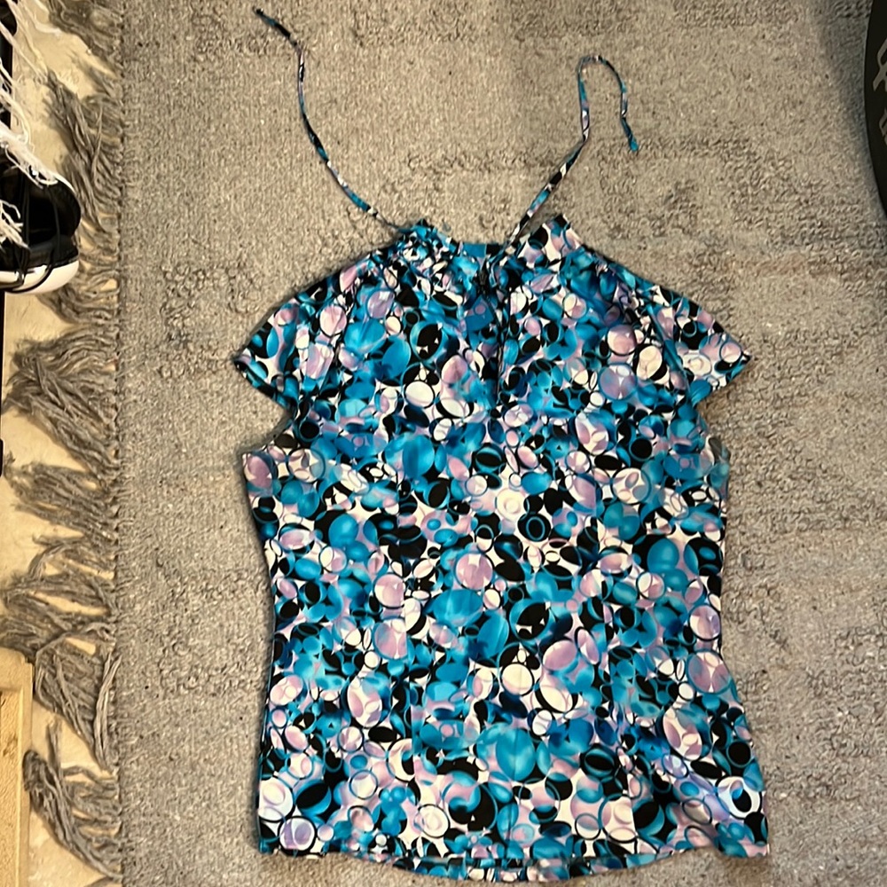 Silk short-sleeve shirt with ruffle neck and ruffle at each sleeve. Cute ties.